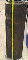 Full height view of the rolled roofing felt next to measuring tape showing ~36 in width