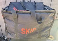 Front view of black insulated bag showing SKIP logo and carry handles