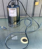 Full view of cylindrical pump with power cord