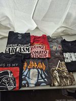 Overview of all six folded graphic T-shirts