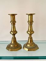 Front view of both brass candlesticks showing full shape