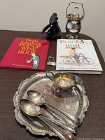 Books, silver-plated tray, spoons, goblet, opener, charm