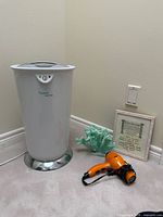 Lot overview showing towel warmer, hair dryer, framed print, faux coral