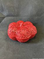 Top view of carved red cinnabar chrysanthemum-shaped lidded box