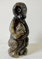 Front view of jade monkey figurine showing overall form and facial details
