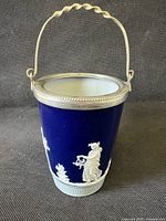 Full view of blue jasperware vase with silver rim and handle