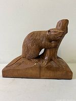 front view of carved beaver on tree trunk