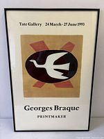 Full view of framed poster showing artwork and exhibition text