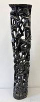 Full view of tall cylindrical ebony tree of life sculpture