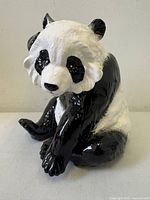 Front three-quarter view of glazed ceramic panda figurine