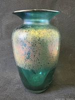 Front view of emerald green iridescent vase showing coloration and shape