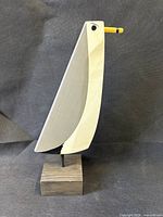 Left side view of carved wood gull on base