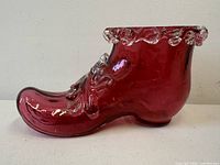 Left side view of cranberry glass shoe showing rigaree detail