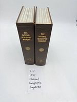 Two brown hardcover bound National Geographic volumes standing upright, showing spines with title and year.