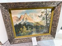 Full view of framed mountain landscape painting