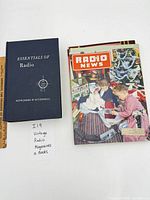 Hardcover book and top Radio News magazine displayed