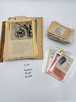 Overview of entire lot: folders with loose pages, stack of recipe cards in bags