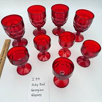 Group shot of 4 larger and 5 smaller ruby red faceted goblets