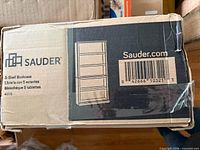 Box end with Sauder branding, shelf count, barcode