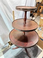 Full view three-tier wooden pedestal table
