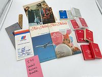 Overview of entire lot showing playing cards, maps, brochure, ticket jackets