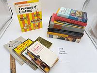 Entire lot arranged: stack of books and one standing book