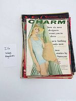 Stack of ten magazines, Charm on top