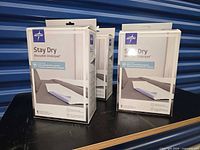 Four sealed Medline StayDry underpad boxes front view