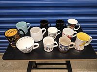 All 12 mugs arranged on table, front and top view