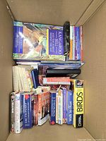 Overview of box showing Kangaroo Bill, dictionaries, thesaurus, Birds volume and other books