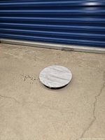 Top view showing round marble surface and size