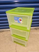 front view of green three-drawer plastic storage unit with original product label visible