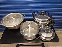 Group view of four lidded pots on table