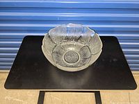 Top front view of clear Arcoroc Fleur glass bowl showing petal relief sides and base medallion