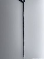 Full length view of black spinel bead strand