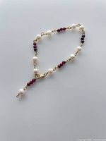 Entire bracelet showing pearls, garnet beads and gold-filled links