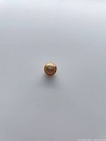 Front view of golden baroque pearl