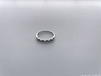 Top view of white gold band with sapphire and diamond stones