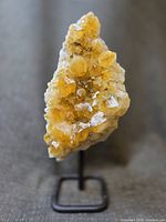 Front view of citrine cluster on stand