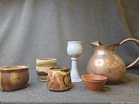 Group shot showing copper pitcher, goblet, and four small planters