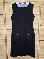 Front view of Karl Lagerfeld black dress showing pockets and neckline