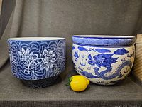 Both blue and white planters side by side with lemon for scale