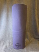 Full rolled view of purple yoga mat showing texture and color