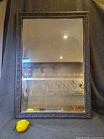 full view of rectangular mirror with ornate frame