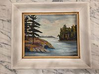 Frontal view of framed painting showing full artwork and frame