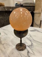 Sphere on silver-plated cup side view