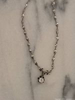 Necklace coiled to show pendant and chain detail