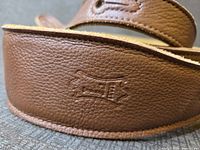 Embossed Levy's logo on brown leather end tab