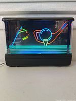Front view illuminated showing golf motif and multicolor tubes
