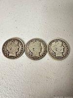 Front view of three Barber Half Dollars dated 1906-1908